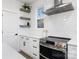 Modern white kitchen with stainless steel appliances and a large island at 10605 S Hampton Dr, Charlotte, NC 28227