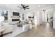 Open concept living room with fireplace, hardwood floors, and access to backyard at 10605 S Hampton Dr, Charlotte, NC 28227