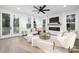 Spacious living room with fireplace, large windows, and comfortable seating area at 10605 S Hampton Dr, Charlotte, NC 28227