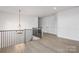 Bright loft area with hardwood floors and a chandelier at 10605 S Hampton Dr, Charlotte, NC 28227