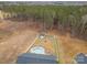 Aerial view shows a large lot with pool, storage building, and fire pit area within fenced backyard at 1076 Furnace Rd, Iron Station, NC 28080