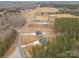 Aerial view showing the properties, driveway, and land, nestled among trees in a rural setting at 1076 Furnace Rd, Iron Station, NC 28080