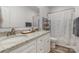 Clean bathroom with dual sinks, light granite countertops, and a shower with a patterned curtain at 1076 Furnace Rd, Iron Station, NC 28080