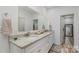 Bright bathroom with double sinks, granite countertops, white cabinets, and a large mirror at 1076 Furnace Rd, Iron Station, NC 28080