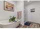 Elegant bathroom with a standalone tub, a glass-enclosed shower, and stylish decor at 1076 Furnace Rd, Iron Station, NC 28080