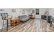 Versatile bonus room with a couch, small dining set, and wooden-style flooring for a flexible living space at 1076 Furnace Rd, Iron Station, NC 28080