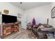 Cozy den featuring hardwood style flooring, comfortable seating and eclectic decor at 1076 Furnace Rd, Iron Station, NC 28080