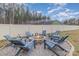 Backyard stone fire pit with Adirondack chairs, perfect for outdoor entertaining and relaxing around the fire at 1076 Furnace Rd, Iron Station, NC 28080