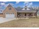 Charming brick home with a covered porch, two car garage and well-manicured front yard at 1076 Furnace Rd, Iron Station, NC 28080