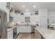 Modern kitchen with white cabinets, stainless steel appliances, and granite countertops at 1076 Furnace Rd, Iron Station, NC 28080
