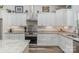 Bright kitchen with white cabinets, granite countertops, stainless steel appliances, and wood flooring at 1076 Furnace Rd, Iron Station, NC 28080
