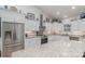 Open kitchen with white cabinets, stainless steel appliances, and granite countertops at 1076 Furnace Rd, Iron Station, NC 28080