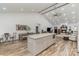 Bright open-concept living room with vaulted ceiling, fireplace, and modern kitchen island at 1076 Furnace Rd, Iron Station, NC 28080