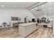 Bright open-concept living room with vaulted ceiling, fireplace, and modern kitchen island at 1076 Furnace Rd, Iron Station, NC 28080