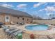 Inviting backyard pool with lounge chairs, patio area, and well-maintained landscaping at 1076 Furnace Rd, Iron Station, NC 28080