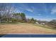 The back of this property features a large and spacious yard with a few trees and a trailer at 1112 Wiscassett St, Albemarle, NC 28001