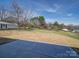 The back of this property features a large and spacious yard with a few trees and a trailer at 1112 Wiscassett St, Albemarle, NC 28001
