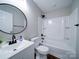 Bathroom featuring a shower-tub combo, round mirror, and modern vanity at 1112 Wiscassett St, Albemarle, NC 28001
