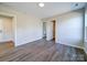 This bedroom features luxury vinyl plank flooring, neutral walls and views to the bathroom at 1112 Wiscassett St, Albemarle, NC 28001