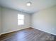 This bedroom features luxury vinyl plank flooring, neutral walls, a large window, and great light at 1112 Wiscassett St, Albemarle, NC 28001
