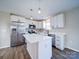 Bright kitchen featuring stainless steel appliances, white cabinetry, an island, and modern pendant lighting at 1112 Wiscassett St, Albemarle, NC 28001