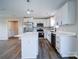 Bright kitchen featuring stainless steel appliances, white cabinetry, an island, and modern lighting at 1112 Wiscassett St, Albemarle, NC 28001