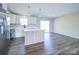 Modern kitchen featuring stainless steel appliances, an island, and seamless flow to living area at 1112 Wiscassett St, Albemarle, NC 28001