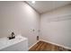 This laundry room features vinyl flooring, a utility sink and connection for a washer and dryer at 1112 Wiscassett St, Albemarle, NC 28001