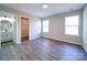 Bedroom with ensuite bathroom and walk-in closet, featuring neutral walls and multiple windows at 1112 Wiscassett St, Albemarle, NC 28001