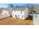 Back of house with vinyl siding, small patio, and fenced yard at 11906 Bending Branch Rd, Charlotte, NC 28227