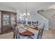 Formal dining room with a large wood table, and a view into the living room at 11906 Bending Branch Rd, Charlotte, NC 28227