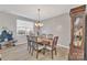 Formal dining room with wooden table and chandelier at 11906 Bending Branch Rd, Charlotte, NC 28227