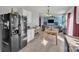 Bright kitchen with white cabinets, black appliances, and a view into the dining area at 11906 Bending Branch Rd, Charlotte, NC 28227