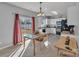 Kitchen with white cabinets, black appliances, and a dining area with glass-top table at 11906 Bending Branch Rd, Charlotte, NC 28227