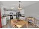 Kitchen features white cabinets, black appliances, and a dining area at 11906 Bending Branch Rd, Charlotte, NC 28227