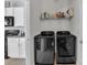 Laundry room with side-by-side washer and dryer and shelving for storage at 11906 Bending Branch Rd, Charlotte, NC 28227