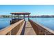 Covered dock with seating area overlooking a tranquil lake at 121 Stormy Pointe Ln, Mooresville, NC 28117