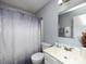 Simple bathroom with a shower/tub combo, vanity, and neutral-toned decor at 12813 Danby Rd, Indian Land, SC 29707