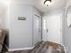 Bright entryway with gray walls, wood-look floors, and white door at 12813 Danby Rd, Indian Land, SC 29707