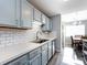 Efficient kitchen featuring light blue cabinets, white subway tile backsplash and stainless steel appliances at 12813 Danby Rd, Indian Land, SC 29707