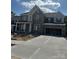 New two-story home with stone and siding, an attached garage, and a concrete driveway at 147 Holsworthy Dr, Mooresville, NC 28115