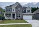 Charming two-story home featuring a stone facade, covered porch, and two-car garage at 147 Holsworthy Dr, Mooresville, NC 28115
