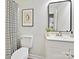 Simple bathroom with white vanity and striped curtain at 173 Brookshire Dr, Fort Mill, SC 29715