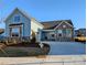 Two-story home features stone and blue siding, a large driveway and landscaped lawn at 2074 Fordhill St, Rock Hill, SC 29732