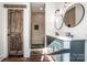 Modern bathroom with double vanity, walk-in shower, and round mirrors at 219 Mock Mill Rd, Statesville, NC 28677