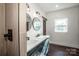 Modern bathroom with double vanity, walk-in shower, and round mirrors at 219 Mock Mill Rd, Statesville, NC 28677