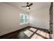 Well lit bedroom with dark wood flooring and ceiling fan at 219 Mock Mill Rd, Statesville, NC 28677