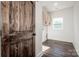 Bright laundry room with wood-look flooring and white cabinets at 219 Mock Mill Rd, Statesville, NC 28677