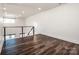 Bright loft area with dark wood flooring and a cable railing at 219 Mock Mill Rd, Statesville, NC 28677