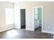 Bright bedroom with wood floors, a window, and doorways to a bathroom and closet at 2220 Badin Rd, Albemarle, NC 28001